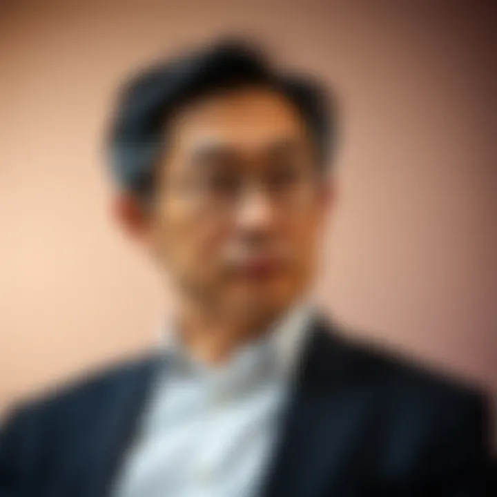 Portrait of Takashi Kotegawa with a thoughtful expression against a soft gradient background